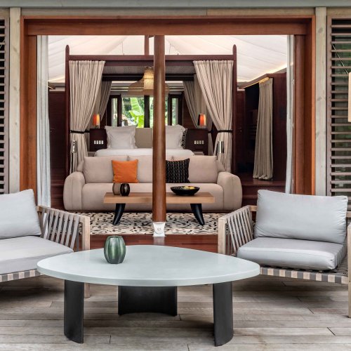 View of the terrace of a tent villa at Sundy Praia, with a focus on the large window into the bedroom.