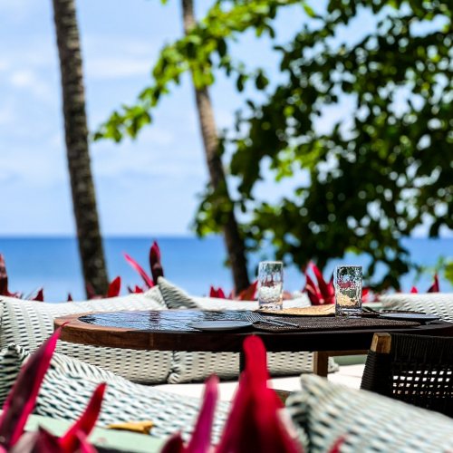 Outdoor dining area with ocean view at Bom Bom Beach Resort.