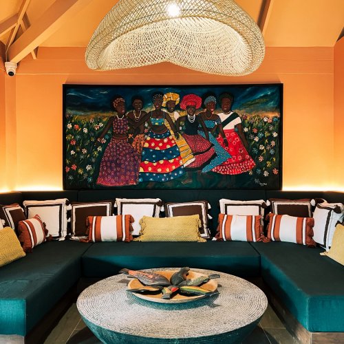 A vibrant living area with artwork and comfortable seating at Bom Bom Beach Resort.