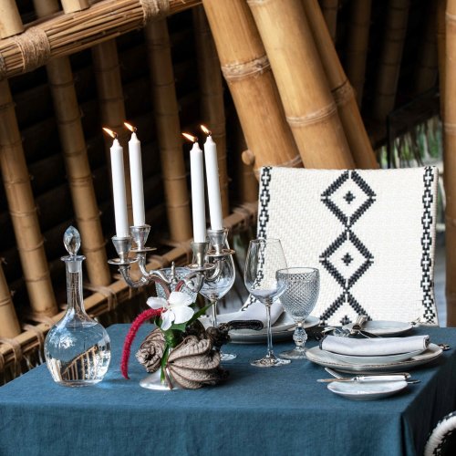 A set table with a blue tablecloth at Oka Sundy Restaurant
