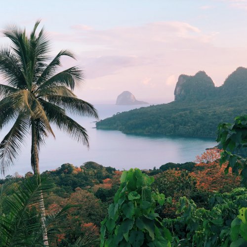 Panoramic view of Príncipe Island with lush forest and a beach in the background