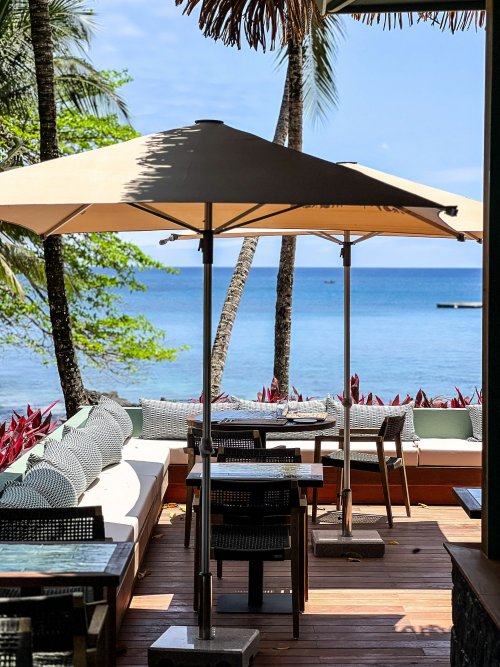 View of the restaurant terrace at Bom Bom with the sea in the background.