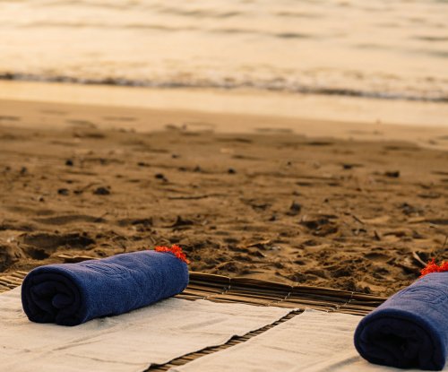Yoga mat on the beach at Bom Bom Beach Resort during sunset.