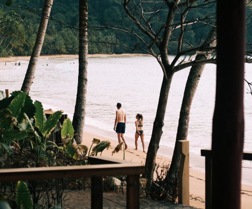 A father and a kid strolling at the beach at Bom Bom Resort.