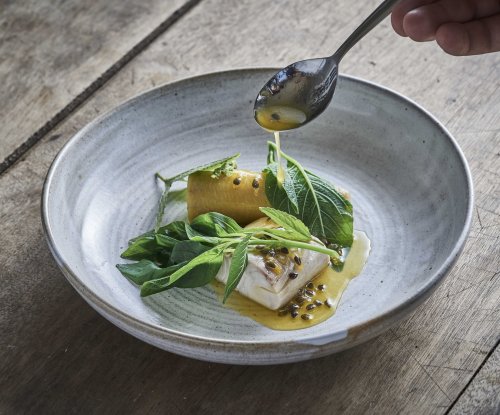 Fine dining dish presented on a table at OKA Sundy restaurant