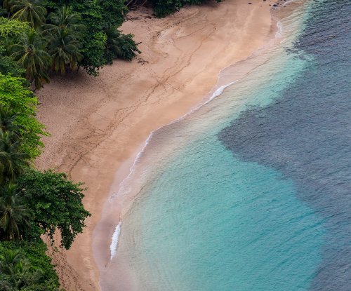 Aerial view of Praia Banana near Hotel Belo Monte, palm-fringed cove for a quiet beach escape