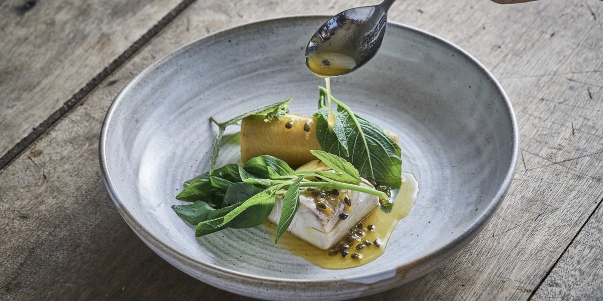 Fine dining dish presented on a table at OKA Sundy restaurant