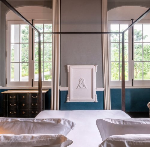 Bright suite at Eclipse House in Roça Sundy with a four-poster bed and garden view